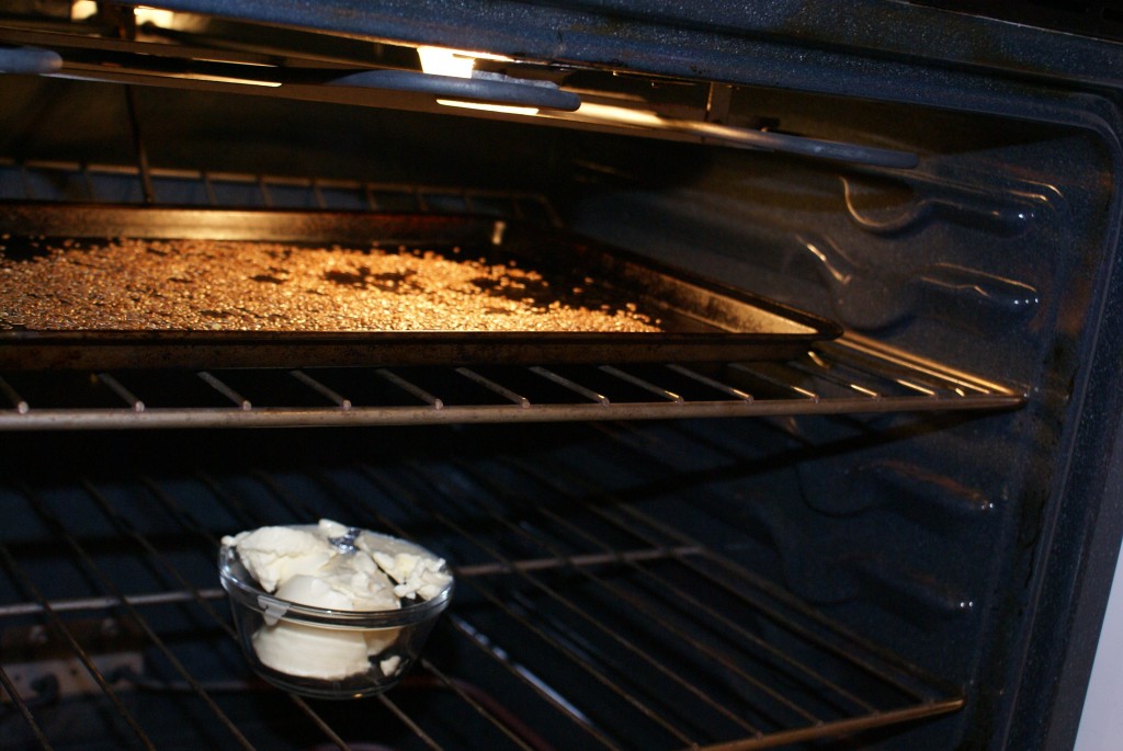 Flax and margarine in over Roasting flax seeds and softening margarine while preheating oven.