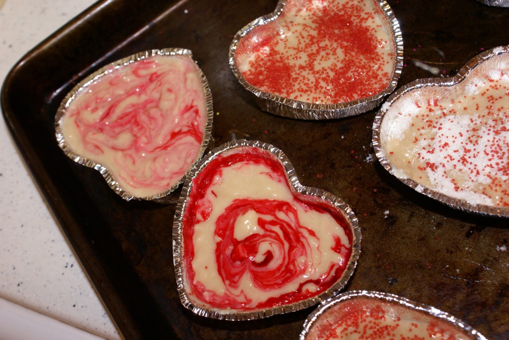 Pink food coloring swirl I used pink food coloring and a toothpick to make swirls in the batter. I also sprinkled a packet of almond tea powder on top some of the cakes before baking to make a sort of crumble topping.