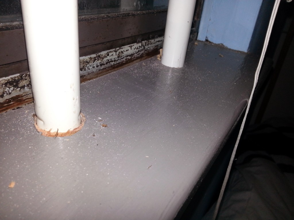 Bottom of the window frame. Still a little dusty from drilling out the holes for the bars.